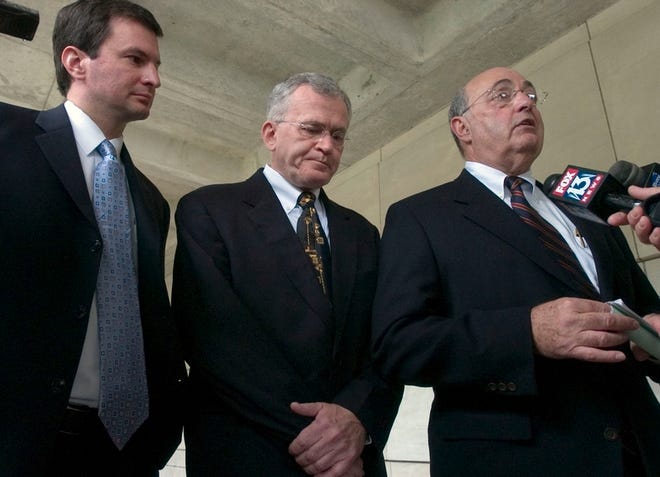 Brian Doyle, a former Department of Homeland Security press aide, center, is flanked by his attorneys, David Martella, left, and Barry Helfand, right, after he pleaded no contest to charges that he had a sexually explicit online relationship with an undercover sheriff's detective posing as a teenage girl.