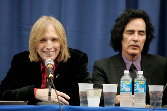 Tom Petty, left, addresses the media at a news conference in the Stephen C. O'Connell Center, Thursday. At right is Ron Blair. Petty hadn't been to Gainesville in 13 years.