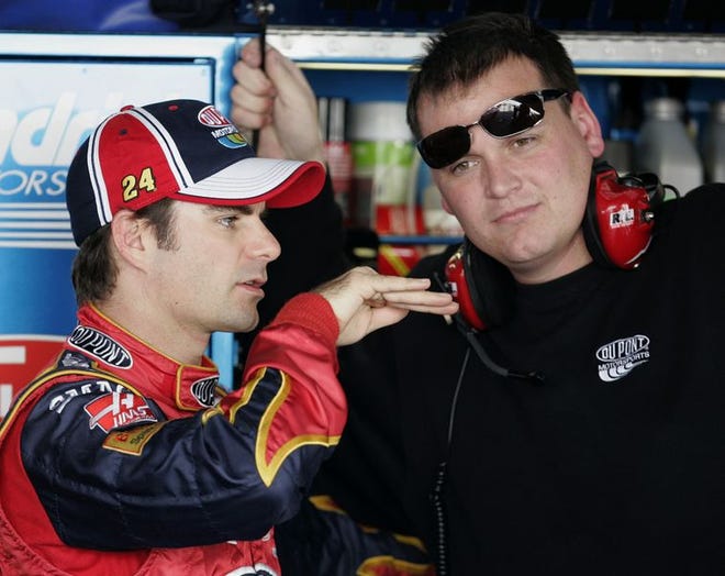 Jeff Gordon, left, describes the racing surface to crew chief Steve Letart during practice Friday. Gordon adjusted well, qualifying on the pole for the Dover 400.
