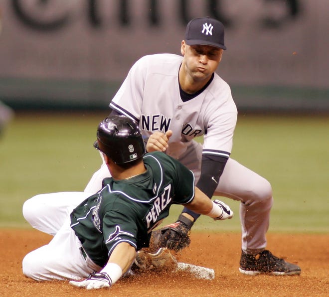 Tampa Bay Devil Rays' Tomas Perez, left, slides in safely ahead of a tag by New York Yankees' Derek Jeter for a fifth-inning double in a baseball game on Friday, Sept. 22, 2006, in St. Petersburg, Fla.
