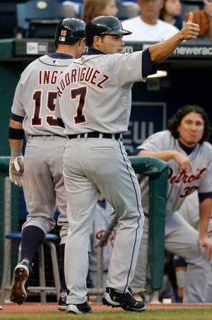 Detroit Tigers' Ivan Rodriguez gives a thumbs up to Placido Polanco after he and Brandon Inge scored.