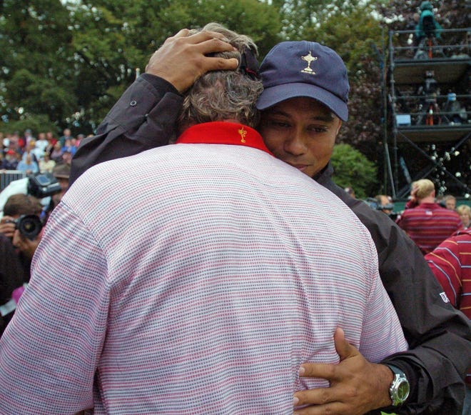 Europe's Darren Clarke, left, is hugged by United States team player Tiger Woods on the 16th green after Clarke won his singles match against Zach Johnson of the United States on the last day of the 2006 Ryder Cup at the K Club golf course, Straffan, Ireland, Sunday Sept. 24, 2006. Clarke won the match 3 and 2. The European team earlier retained the Ryder Cup. (AP Photo/PA, Rui Vieira) ** EDITORIAL USE ONLY UNITED KINGDOM OUT NO SALES NO ARCHIVE  **