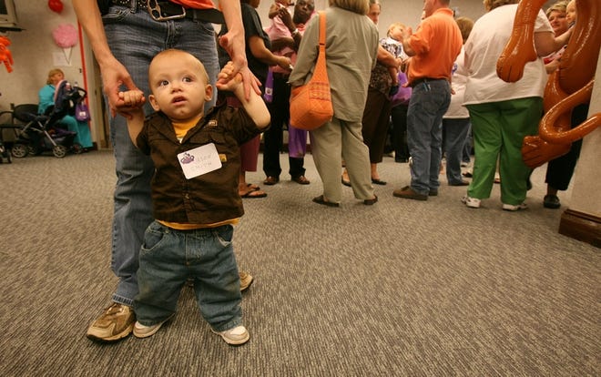 Ten-month-old Jason Smith walks with his mother, Emily Herrin, at a reunion for former patients of the Neonatal Intensive Care Unit at DCH Regional Medical Center in Tuscaloosa. Smith, who lives in West Blocton, was born one month early with lung complications.