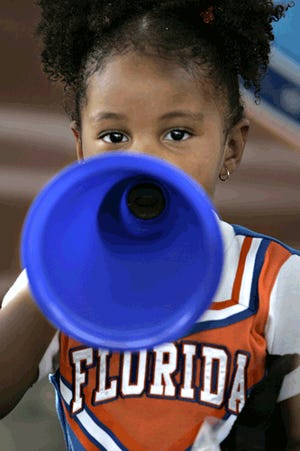 Aiyanna Hopkins, 3, of Gainesville, plays with a megaphone before the Florida vs. Southern Mississippi game earlier this month. If your little one doesn't get overwhelmed by crowds or noise, they might enjoy the pageantry of a Gator football game.