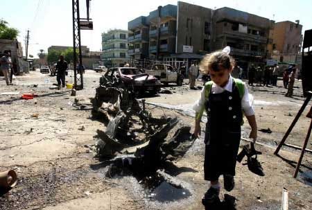 Iraqi girl takes home her older sister's shoes from a site near Abu Tibeekh restaurant in Sadoun Street in central Baghdad Thursday, Sept. 28, 2006, where a car bomb explosion killed five people and wounded 34. It was unclear if her sister was injured in the attack.
			AP photo