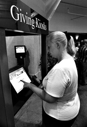 Sharon Byrum makes a church donation on an ATM-like device in Augusta, Ga.