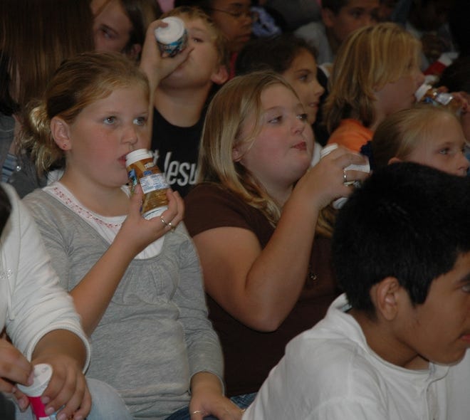 Suwannee County Middle School students toast a decision to switch from square milk cartons to plastic bottles this year.