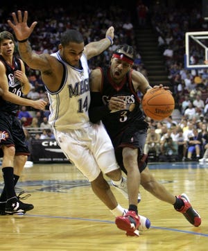 Orlando's Jameer Nelson (14) fouls the 76ers' Allen Iverson (3) as he drives to the basket in the first half.