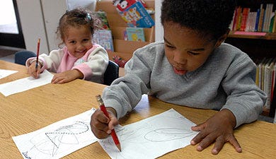Children’s Discovery Center students Dante Clark, right, and Da’minique Watkins, both 2 years old, scribble on paper Thursday after tracing letters and numbers.