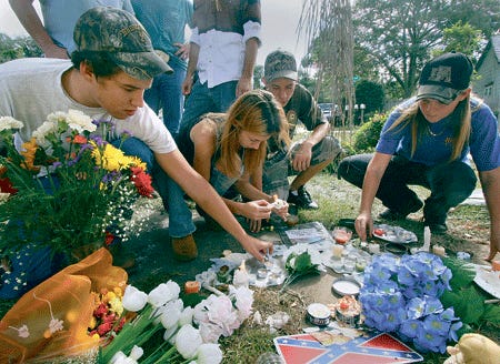 Friends of Dakota Lee Evans, from left to right, Marshall Whitaker, 18, Samantha Brown, 16, Adam Amicone, 16, and Leighann Whitehead, 18, light candles for the teen at a roadside memorial near where he died along Oak Lane in Lakeland.