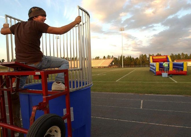 Conlee Stone, 15, a sophomore, helps set up the dunking booth for Midland Valley High School's Fun Night, which drew more than 1,000 revelers.