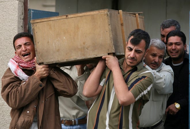 Iraqis carry the coffin of their relative, a victim of sectarian violence, outside Baghdad's Yarmouk hospital Tuesday.