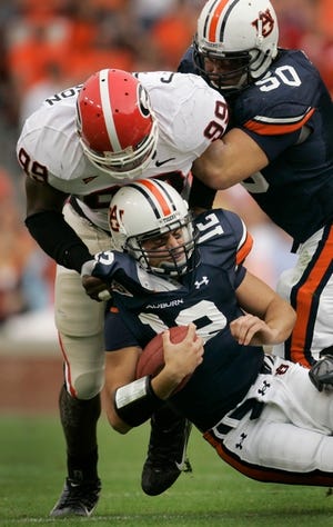 Auburn's Will Herring (35) is unable to stop Georgia's Kregg Lumpkin from scoring a touchdown during the first half at Jordan-Hare Stadium in Auburn, Ala. The Associated Press