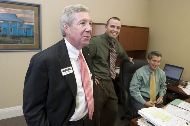 From left, First Avenue National Bank President John R. Hunt, Jason Welborn and Pat Moses are seen Tuesday at the new bank, seen below at 206 S.W. 10th St. Hunt touts the bank's local control.
