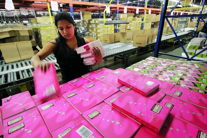 Martha Carchi prepares to ship books ordered online at the Barnes & Noble Distribution Center in Monroe Township, N.J., last week. Half of American
consumers plan to shop online this holiday season, up from 36 percent three years ago, according to the National Retail Federation. Associated Press