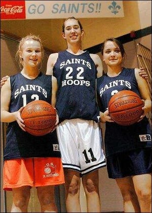 The St. Thomas Aquinas girls basketball team will be led this season by captains, from left, junior Shannon Kean, and seniors Emily Sheehan and Laura Frasier.