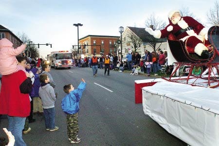 Santa Claus waves to a fan during the Dover Holiday Parade.