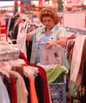 Debra Lewis shops at Marshalls department store in the Mullins Crossing shopping center, which some officials say has contributed to increased sales figures. Sales tax collections in Columbia County continue to reach record-breaking levels.