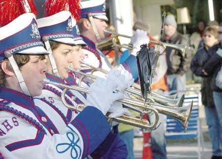 The Winnacunnet Warrior Band plays while it marches along Route 1 in downtown Hampton during Saturday's annual Christmas Parade.