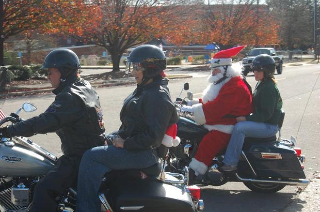 George and Pam Stickler are followed by Santa Claus. More than 30 bikers rode to raise money for the RECing Crew, a charity that helps disabled children and adults.