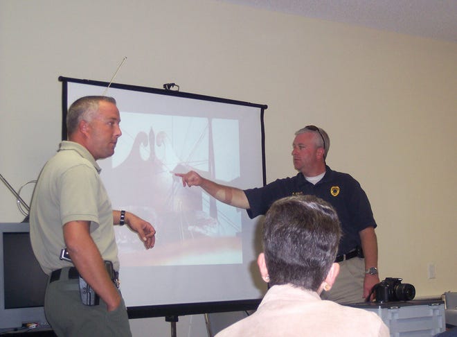 Effingham County Sheriff's Department Crime Scene Investigation Unit officers Pete Hossalla, left, and Alan Elliott share slides of real crime scenes and the techniques they use to process them with participants in Bloomingdale's Citizens Police Academy.