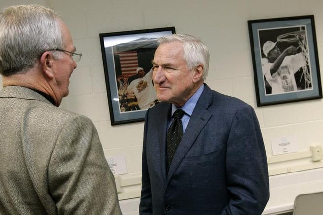 Former North Carolina coach Dean Smith (right) talks with Tar Heels announcer Woody Durham on Friday afternoon. Smith's all-time men's victory record 879 will soon be passed by Bob Knight.