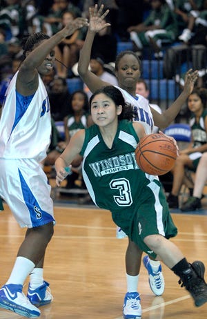Windsor Forest's Christine Phan eyes the basket as she dribbles past Savannah High's Brittany Starr and Tiffany Mitchell during Friday's game.