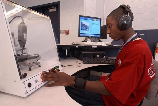 Seventh-grader Damon Haris, 13, learns about computer numeric control manufacturing in the synergistic lab at Schofield Middle School in Aiken. The pupils try an occupation for seven days.
