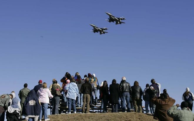 Spectators watch F-16's perform drills during South Carolina Air National Guard Day in Eastover, S.C.