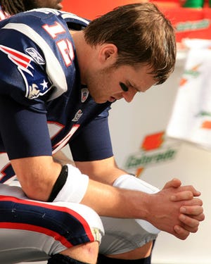 Quarterback Tom Brady hangs his head during the Patriots' 21-0 loss to the Dolphins.