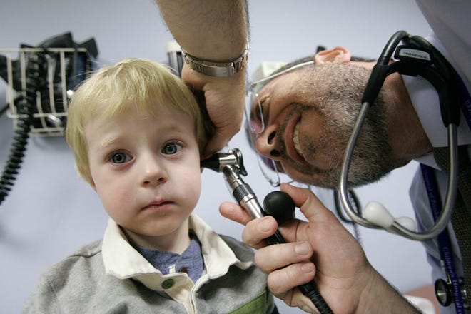 Giancario Gemignani-Hernandez, 2, has his ear examined by Dr. Alejandro Hoberman at Children's Hospital of Pittsburgh.