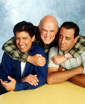 Peter Boyle, center, poses with Ray Romano, left, and Brad Garrett, who played his sons on "Everybody Loves Raymond." Boyle, who played their curmudgeonly father, died Tuesday in a New York hospital.