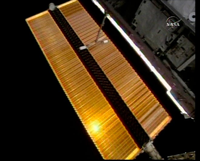 In this image from NASA Television shows a wide view of the solar panel on the right that appeared to correct itself after being redeployed on the international space station, Wednesday, Dec. 13, 2006.