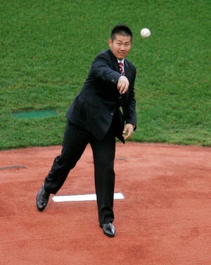 Japanese pitcher Daisuke Matsuzaka delivers a pitch from the Fenway Park mound in Boston shortly before a press conference that made his deal with the Red Sox official.
