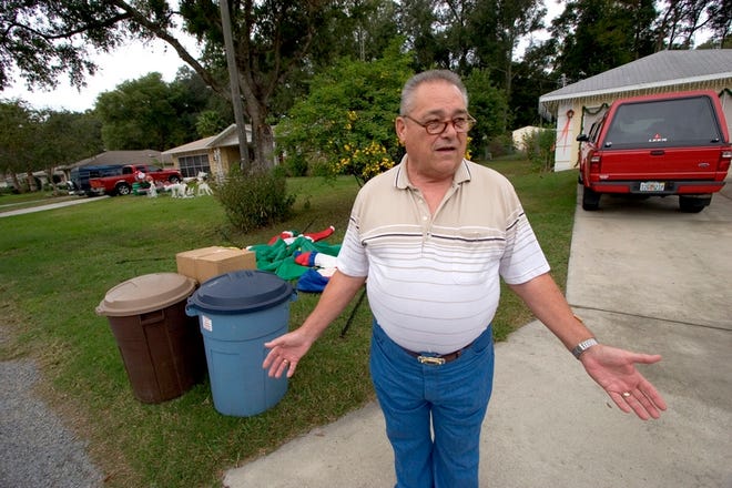 Bill Greenlow stands next to his trash, which was not picked up by Andy's Garbage Service. The county revoked the business' franchise.