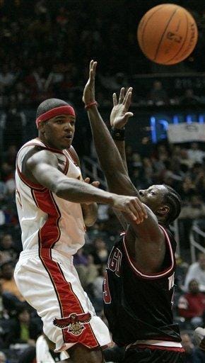 Atlanta Hawks' Josh Smith, left, passes under pressure from Chicago Bulls' Ben Wallace during the second half.