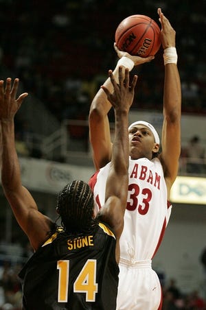 Alabama’s Jermareo Davidson (33) goes up for a shot over Southern Mississippi’s Sai’Quon Stone during Saturday’s game in Mobile. Davidson was one blocked shot away from a triple double in the Tide’s win. He blocked nine shots, scored 25 points and had 11 rebounds.