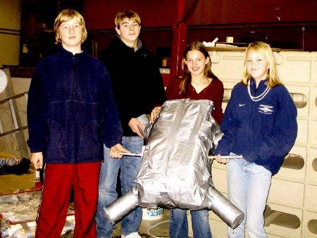 Students hold up the boat they designed for a school project. From left are Jon Collyer, Brent Edmunds, Kinsey Davenport and Ashley Maclaughlin.
			Laura Mellow photo