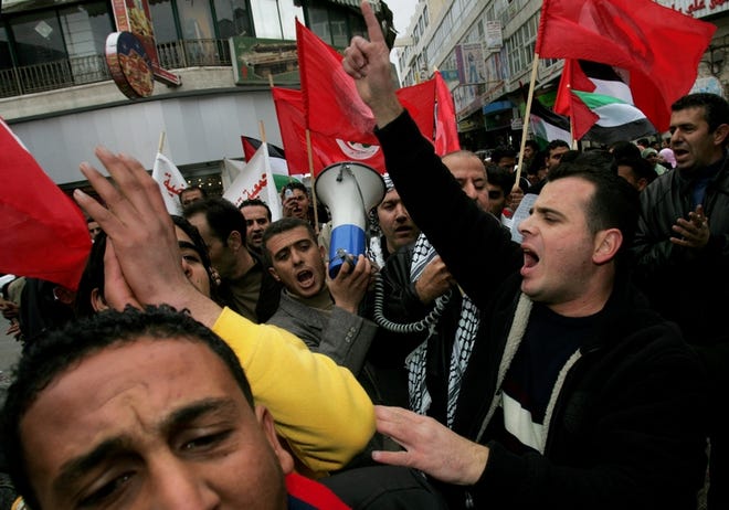 Supporters of the Palestinian Communist Party chant anti-government slogans during a rally against internal Palestinian fighting Tuesday in Ramallah, West Bank.
