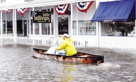 A man canoes passed Shelton?s and Gabby Sullivan?s in York during last spring?s historic flooding.