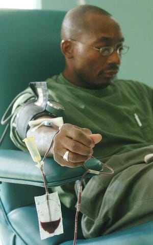 Dwight Hollaway donated blood at Shepeard Community Blood Center in Augusta on Wednesday.