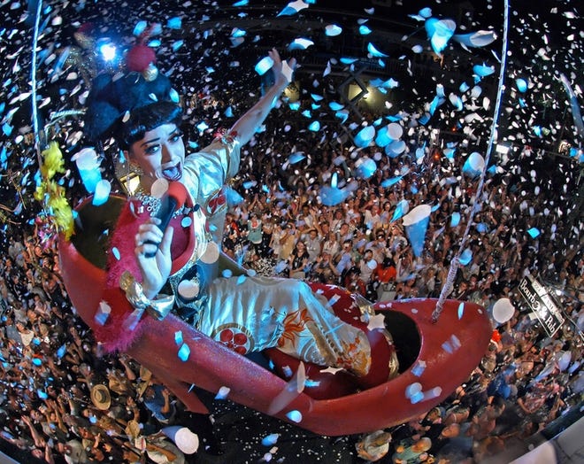 "Sushi," as portrayed by female impersonator Gary Marion, talks to a sea of revelers in a replica of a woman's high heel shoe, prior to being lowered to Duval Street in Key West to celebrate the dawn of 2006 at the Bourbon Street Pub. Marion is scheduled to ride in the shoe for the 10th consecutive year Sunday as a facet of New Year's Eve activities.