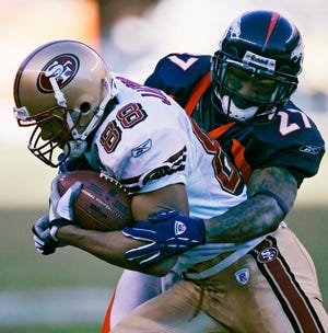 Denver Broncos cornerback Darrent Williams, right, tackles San Francisco 49ers receiver Taylor Jacobs on Sunday. Williams was shot and killed early Monday morning in Denver.