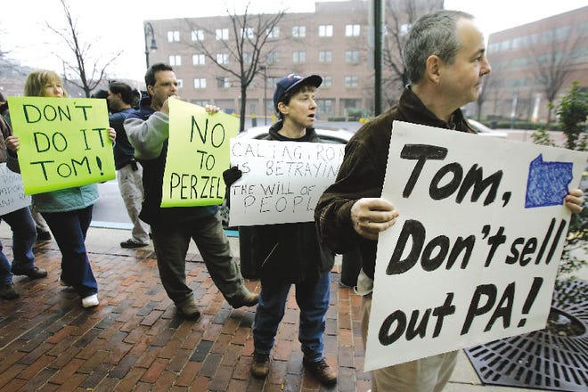 Demonstrators picket outside the office of state Rep. Thomas R. Caltagirone, D-Berks, Monday in Reading.