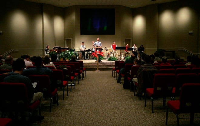 Community life pastor Wes Fondren gives the opening announcements during the morning service at Grace Church on Dec. 24, 2006. The congregation has worshiped in the new building on Hargrove Road for about six months.