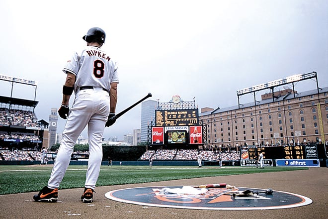 Infielder Cal Ripken Jr. #8 of the Baltimore Orioles waiting to bat during the game against the Boston Red Sox at the Orioles Park at Camden Yards in Baltimore, Maryland.