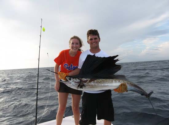 Kayla with friend and her defeated sailfish