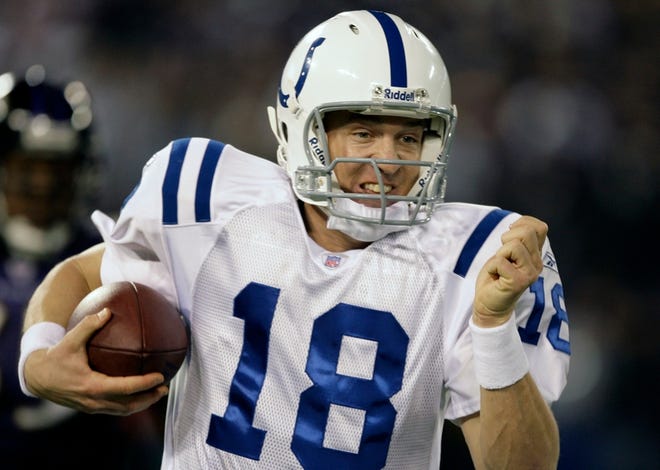 Indianapolis Colts quarterback Peyton Manning grits his teeth as he scrambles during the second quarter against the Ravens in Baltimore on Saturday.
