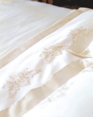 Embroidered Topkapi bed linens from Yves Delorme have a satin weave, which produces a softer ‘feel' than a classic linen weave.