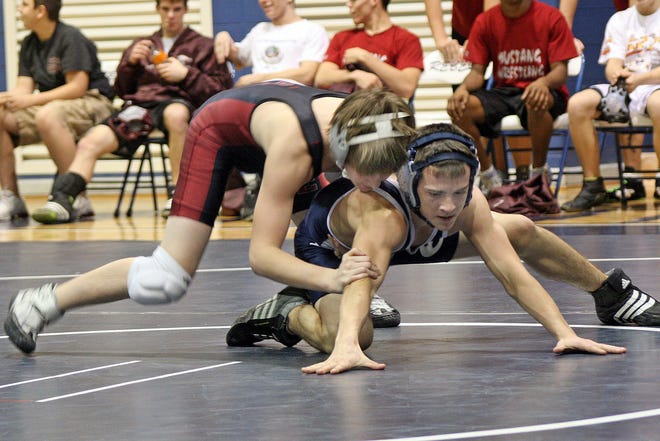 South Effingham's Alex Wendell and Effingham County's Josh Barnhill struggle for control during the 103-pound match on Tuesday. Barnhill won the match 13-8.